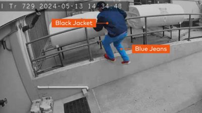 security-camera-detection security camera footage showing a man by railing, indicating detection of his black jacket and blue jeans